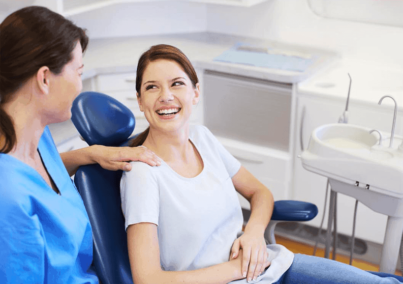 Woman smiling after dental implant treatment in Jersey