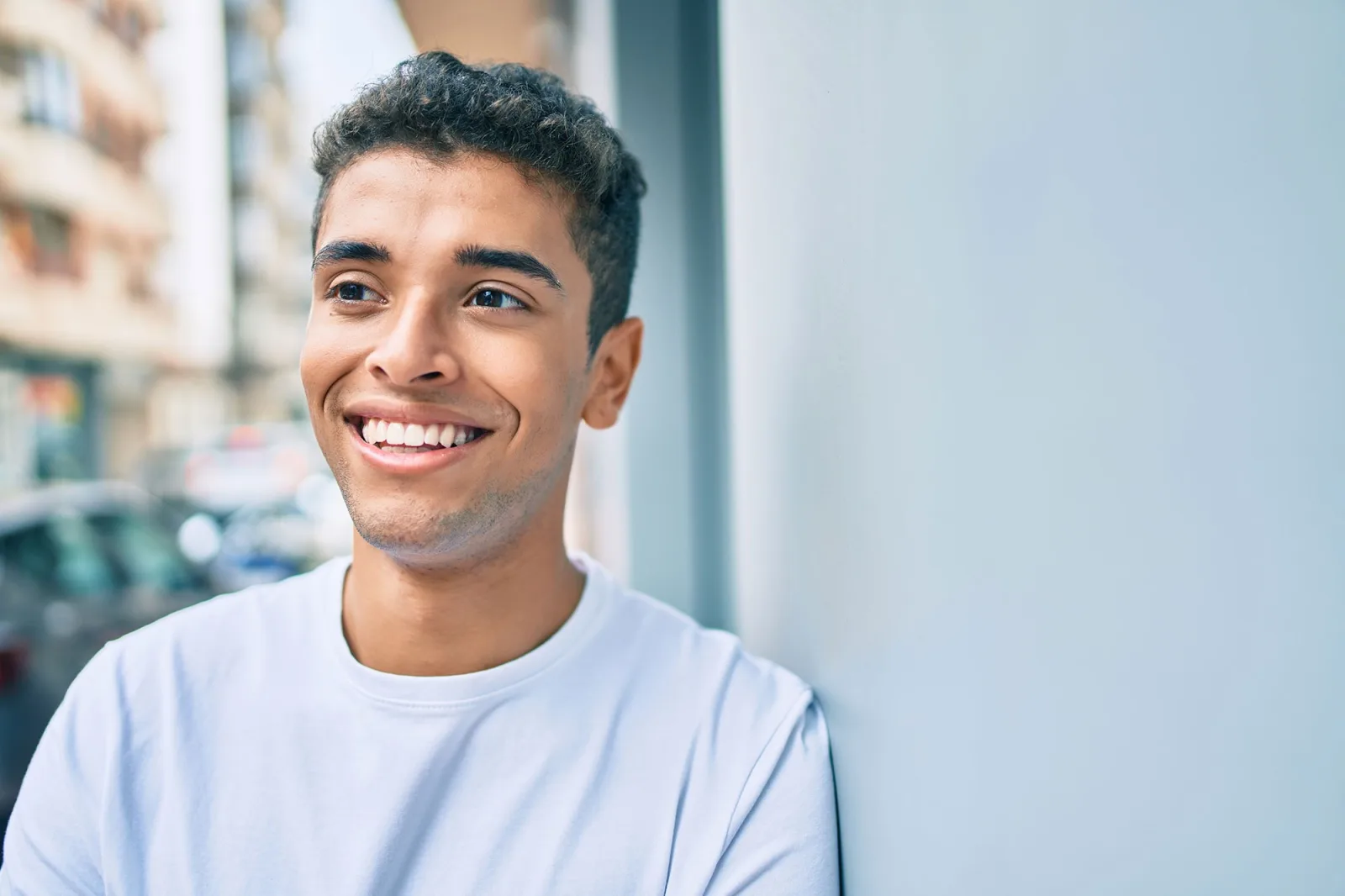 Smiling young man showcasing a healthy, bright smile at Indigo Dental Practice, Jersey